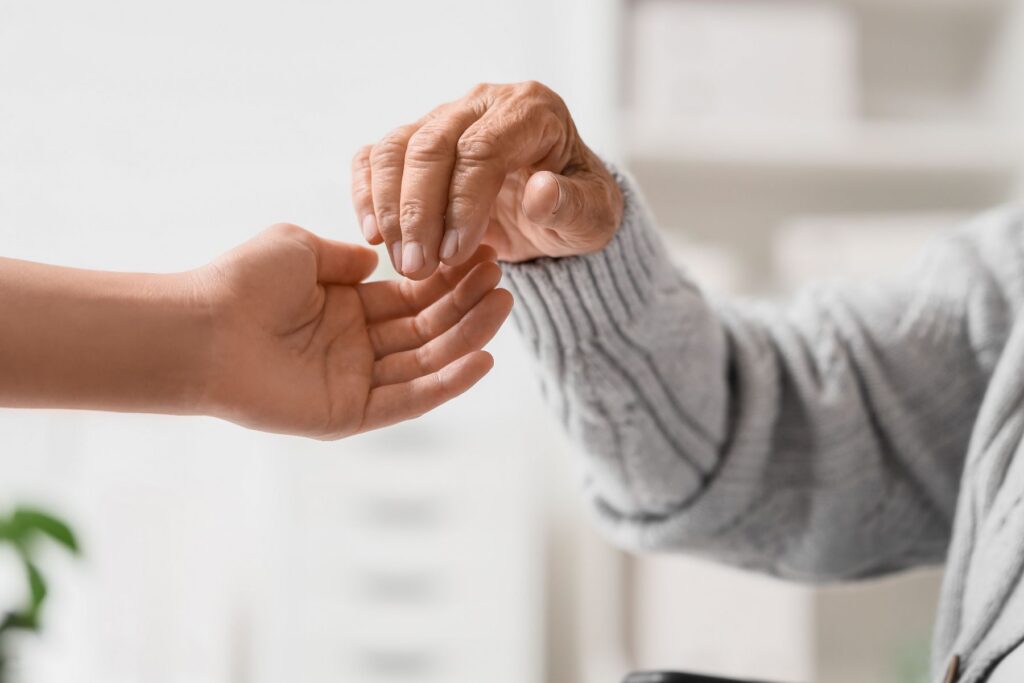 Two hands together showing what feeling supported in senior living looks like.